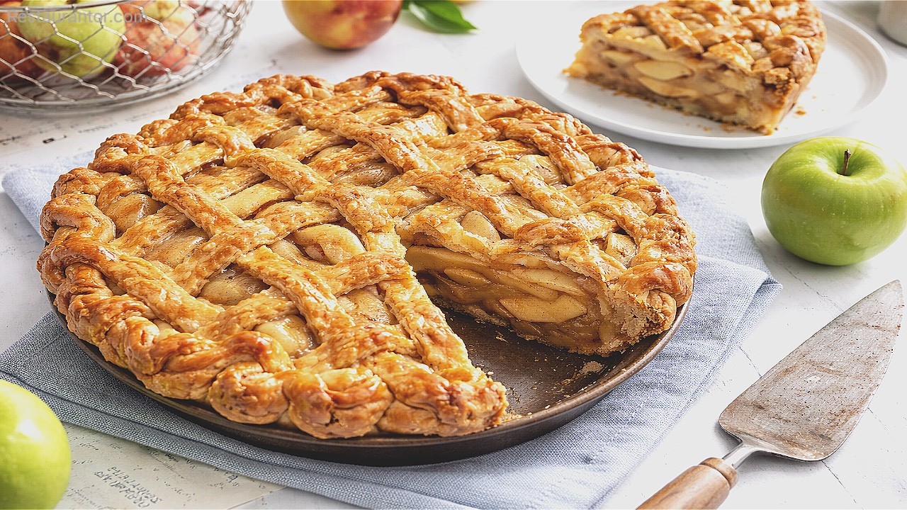 Lattice Crust fresh Apple Pie with a slice on a plate