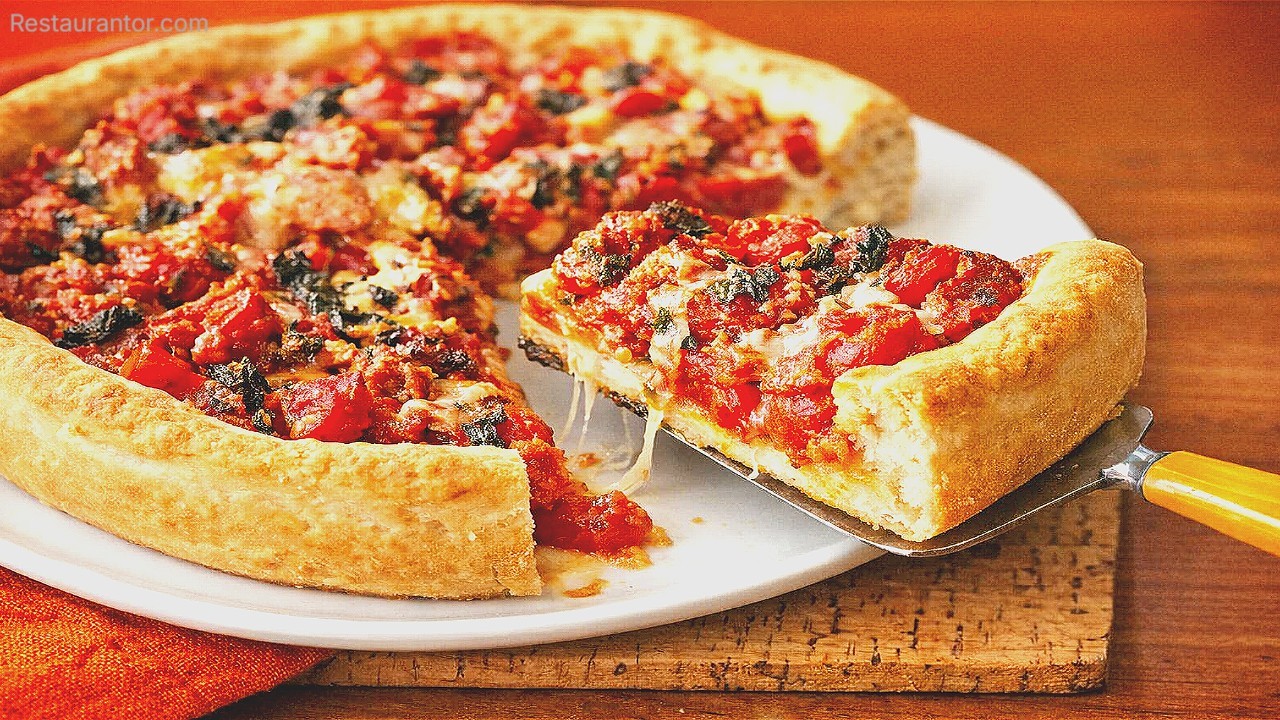Chicago deep-dish pizza with thick crust and chunky tomato topping, slice lifted on a spatula